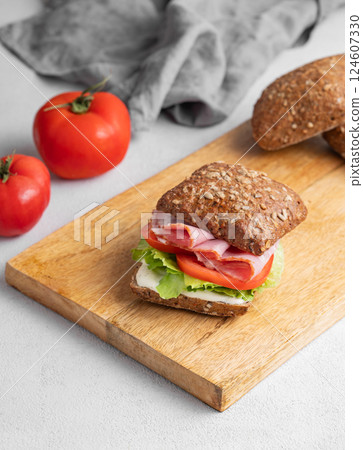 Toast sandwich made of grain bread with prosciutto, cheese, tomatoes, lettuce and sauce Toast sandwich made of grain bread with prosciutto, cheese, tomatoes, lettuce and sauce 124607330