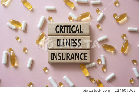 Critical Illness Insurance symbol. Concept word Critical Illness Insurance on wooden blocks. Beautiful pink background with pills. Medicine and Critical Illness Insurance concept. Copy space 124607365