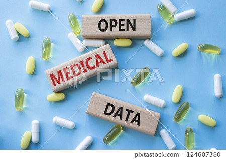 Open Medical Data symbol. Concept word Open Medical Data on wooden blocks. Beautiful blue background with pills. Medicine and Open Medical Data concept. Copy space Open Medical Data symbol. Concept word Open Medical Data on wooden blocks. Beautiful blue background with pills. Medicine and Open Medical Data concept. Copy space 124607380