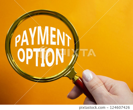Payment Option symbol. Concept words Payment Option on magnifying glass. Businessman hand. Beautiful orange background. Business and Payment Option concept. Copy space. Payment Option symbol. Concept words Payment Option on magnifying glass. Businessman hand. Beautiful orange background. Business and Payment Option concept. Copy space. 124607426