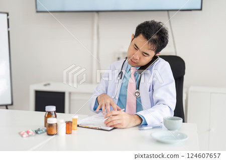 Telemedicine and Patient Trust. A doctor focusing on a patient's needs during a telehealth call while managing medication details. 124607657