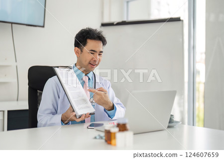 Remote Consultation and Patient Care. A healthcare provider engaged in online consultation, presenting a medical document to the patient. 124607659