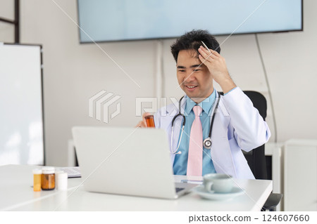 Telemedicine and Medication Review. A doctor analyzes patient prescriptions during an online consultation to ensure proper treatment. 124607660