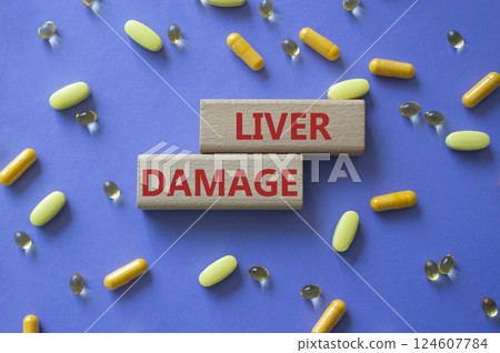Liver Damage symbol. Concept word Liver Damage on wooden blocks. Beautiful purple background with pills. Medicine and Liver Damage concept. Copy space Liver Damage symbol. Concept word Liver Damage on wooden blocks. Beautiful purple background with pills. Medicine and Liver Damage concept. Copy space 124607784