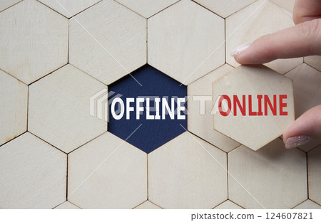 Offline or Online symbol. Concept word Offline or Online on wooden comb puzzle. Businessman hand. Beautiful deep blue background. Business and Offline or Online concept. Copy space 124607821