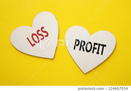 Profit or Loss symbol. Concept word Profit or Loss on wooden hearts. Beautiful yellow background. Business and Profit or Loss concept. Copy space Profit or Loss symbol. Concept word Profit or Loss on wooden hearts. Beautiful yellow background. Business and Profit or Loss concept. Copy space 124607834