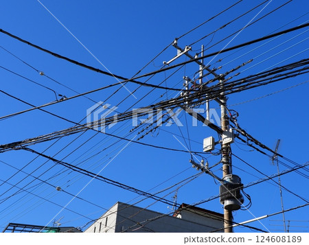 A refreshing blue sky and a utility pole 124608189