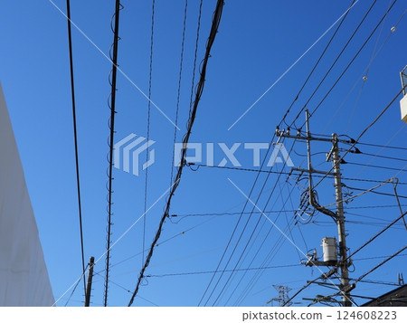 A refreshing blue sky and a utility pole 124608223