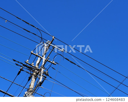 The railroad tracks continue. Electric wires and sky. The blue sky feels good. Copy space. 124608483