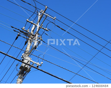 The railroad tracks continue. Electric wires and sky. The blue sky feels good. Copy space. 124608484