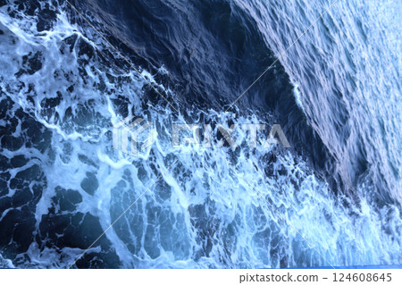 Watery waves churn and foam, a dark blue expanse Watery waves churn and foam, a dark blue expanse 124608645