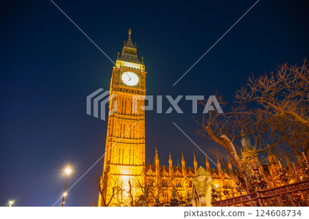 Big Ben stands majestically against the night sky in London, with its golden hue radiating warmth. Big Ben stands majestically against the night sky in London, with its golden hue radiating warmth. 124608734