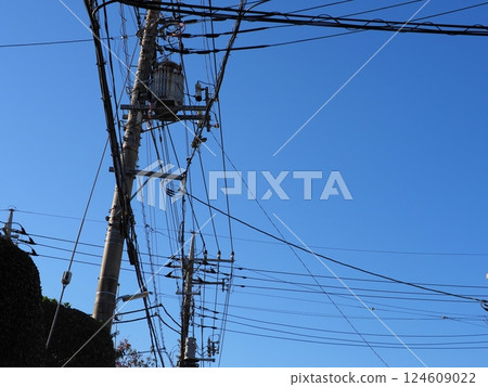 A tower towering in the blue sky, clear sky and electric poles, copy space 124609022