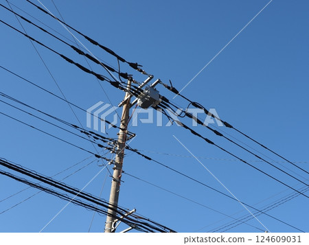 A tower towering in the blue sky, clear sky and electric poles, copy space A tower towering in the blue sky, clear sky and electric poles, copy space 124609031