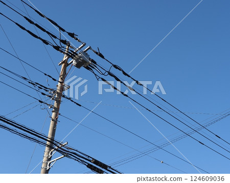A tower towering in the blue sky, clear sky and electric poles, copy space A tower towering in the blue sky, clear sky and electric poles, copy space 124609036