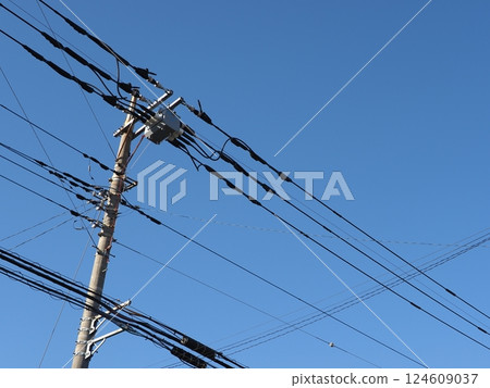 A tower towering in the blue sky, clear sky and electric poles, copy space A tower towering in the blue sky, clear sky and electric poles, copy space 124609037
