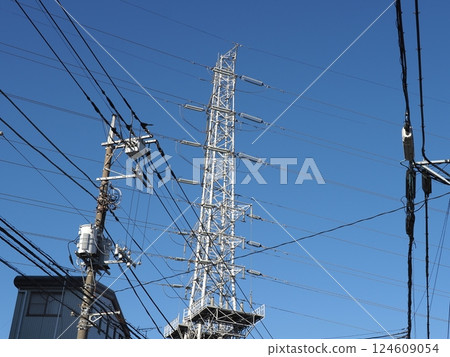 A tower towering in the blue sky, clear sky and electric poles, copy space 124609054