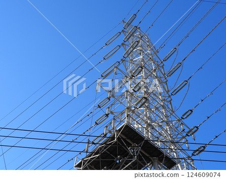 A tower towering in the blue sky, clear sky and electric poles, copy space A tower towering in the blue sky, clear sky and electric poles, copy space 124609074