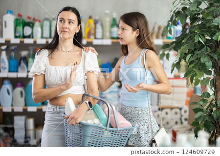 Tired mother with capricious daughter in household chemicals store 124609729