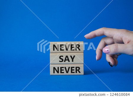 Never say Never symbol. Concept words Never say Never on wooden blocks. Businessman hand. Beautiful blue background. Business and Never say Never concept. Copy space Never say Never symbol. Concept words Never say Never on wooden blocks. Businessman hand. Beautiful blue background. Business and Never say Never concept. Copy space 124610084