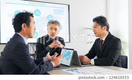 A group of middle-aged male business people meeting in a conference room A group of middle-aged male business people meeting in a conference room 124610553