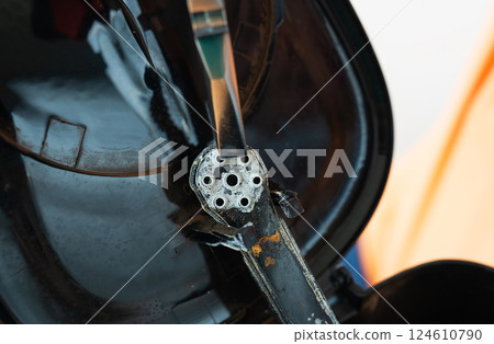 Close-up of a rusty, aged coffee grinder's internal mechanism, showcasing its worn metal components and coffee residue Close-up of a rusty, aged coffee grinder's internal mechanism, showcasing its worn metal components and coffee residue 124610790