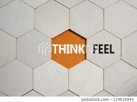 Think or Feel symbol. Concept word Think or Feel on wooden comb puzzle. Beautiful orange background. Business and Think or Feel concept. Copy space 124610843