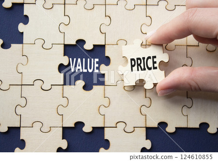 Price and Value symbol. Concept word Price and Value on wooden puzzle. Businessman hand. Beautiful deep blue background. Business and Price and Value concept. Copy space 124610855