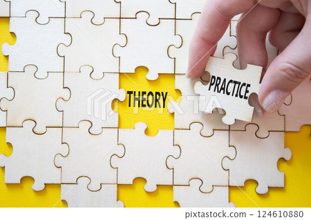 Theory or Practice symbol. Concept word Theory or Practice on wooden puzzle. Businessman hand. Beautiful yellow background. Business and Theory or Practice concept. Copy space Theory or Practice symbol. Concept word Theory or Practice on wooden puzzle. Businessman hand. Beautiful yellow background. Business and Theory or Practice concept. Copy space 124610880