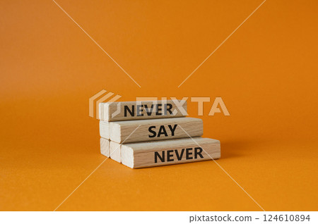 Never say Never symbol. Concept words Never say Never on wooden blocks. Beautiful orange background. Business and Never say Never concept. Copy space Never say Never symbol. Concept words Never say Never on wooden blocks. Beautiful orange background. Business and Never say Never concept. Copy space 124610894