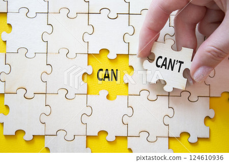 Can or Cant symbol. Concept word Can or Cant on wooden puzzle. Businessman hand. Beautiful yellow background. Business and Can or Cant concept. Copy space Can or Cant symbol. Concept word Can or Cant on wooden puzzle. Businessman hand. Beautiful yellow background. Business and Can or Cant concept. Copy space 124610936