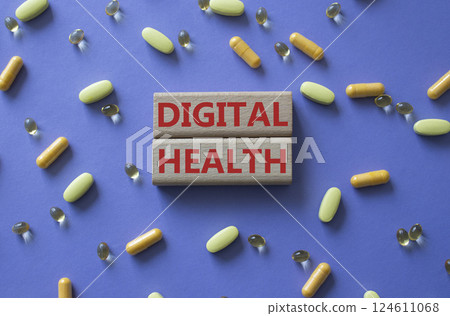 Digital Health symbol. Concept word Digital Health on wooden blocks. Beautiful purple background with pills. Medicine and Digital Health concept. Copy space 124611068
