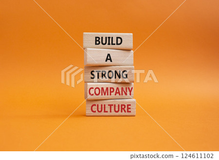 Company culture symbol. Wooden blocks with words Build a strong company culture. Beautiful orange background. Business and Company culture concept. Copy space. 124611102