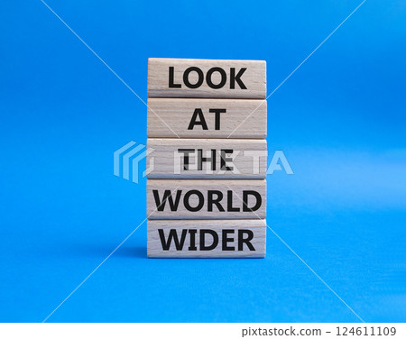 Look at the world wider symbol. Wooden blocks with words Look at the world wider. Beautiful blue background. Business and Look at the world wider concept. Copy space. 124611109