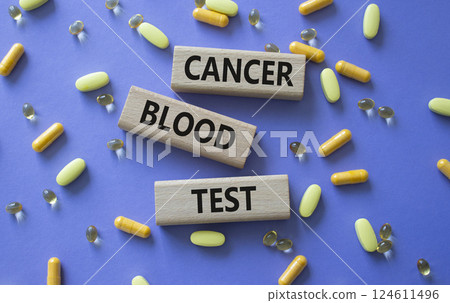 Cancer Blood Test symbol. Concept word Cancer Blood Test on wooden blocks. Beautiful purple background with pills. Medicine and Cancer Blood Test concept. Copy space 124611496