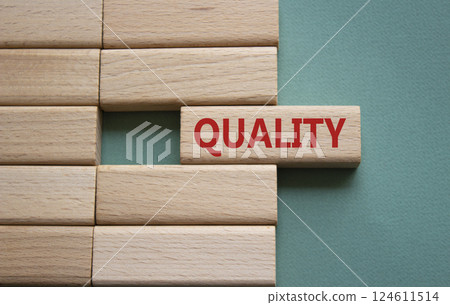 Quality symbol. Concept word Quality on wooden blocks. Beautiful grey green background. Business and Quality concept. Copy space. Quality symbol. Concept word Quality on wooden blocks. Beautiful grey green background. Business and Quality concept. Copy space. 124611514