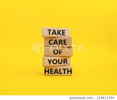 Health symbol. Wooden blocks with words Take Care of your Health. Beautiful yellow background. Health concept. Copy space. Health symbol. Wooden blocks with words Take Care of your Health. Beautiful yellow background. Health concept. Copy space. 124611594