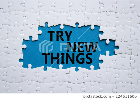 Try new Things symbol. Concept words Try new Things on white puzzle. Beautiful blue background. Business and Try new Things concept. Copy space. Try new Things symbol. Concept words Try new Things on white puzzle. Beautiful blue background. Business and Try new Things concept. Copy space. 124611600
