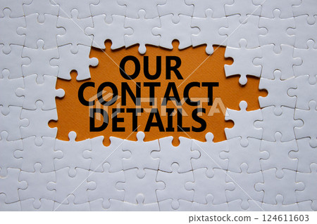 Our Contact Details symbol. Concept words Our Contact Details on white puzzle. Beautiful orange background. Business and Our Contact Details concept. Copy space. 124611603