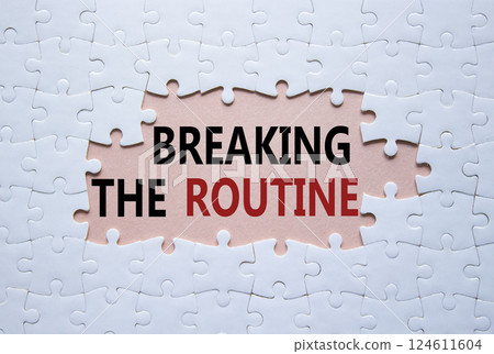 Breaking the Routine symbol. White puzzle with words Breaking the Routine. Beautiful pink background. Business and Breaking the Routine concept. Copy space. 124611604