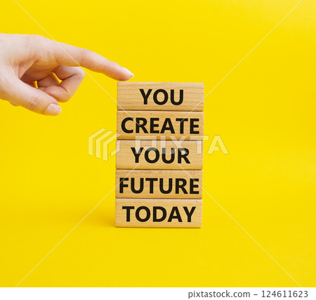 Future and development symbol. Wooden blocks with words You Create your Future today. Businessman hand. Businessman hand. Beautiful blue background. Business and Future and development concept. Copy 124611623