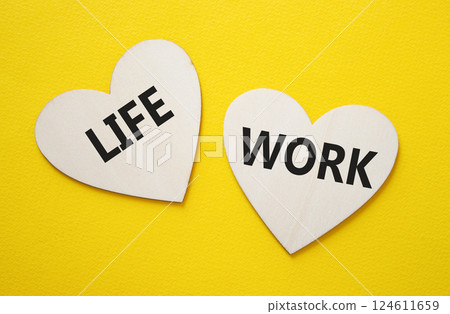 Life or Work symbol. Concept word Life or Work on wooden hearts. Beautiful yellow background. Business and Life or Work concept. Copy space Life or Work symbol. Concept word Life or Work on wooden hearts. Beautiful yellow background. Business and Life or Work concept. Copy space 124611659