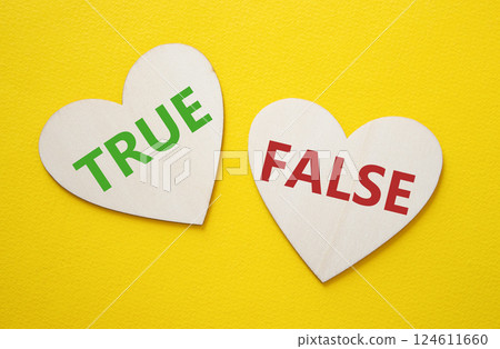 True or False symbol. Concept word True or False on wooden hearts. Beautiful yellow background. Business and True or False concept. Copy space True or False symbol. Concept word True or False on wooden hearts. Beautiful yellow background. Business and True or False concept. Copy space 124611660