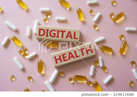 Digital Health symbol. Concept word Digital Health on wooden blocks. Beautiful pink background with pills. Medicine and Digital Health concept. Copy space 124611686