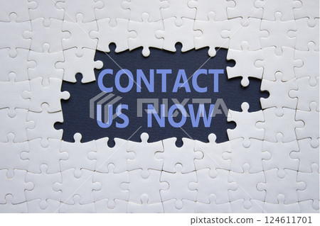 Contact us now symbol. White puzzle with words Contact us now. Beautiful deep blue background. Business and Contact us now concept. Copy space. 124611701