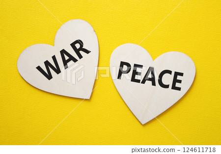 War or Peace symbol. Concept word War or Peace on wooden hearts. Beautiful yellow background. Business and War or Peace concept. Copy space War or Peace symbol. Concept word War or Peace on wooden hearts. Beautiful yellow background. Business and War or Peace concept. Copy space 124611718