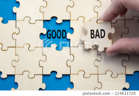 Good or Bad symbol. Concept word Good or Bad on wooden puzzle. Businessman hand. Beautiful blue background. Business and Good or Bad concept. Copy space Good or Bad symbol. Concept word Good or Bad on wooden puzzle. Businessman hand. Beautiful blue background. Business and Good or Bad concept. Copy space 124611720