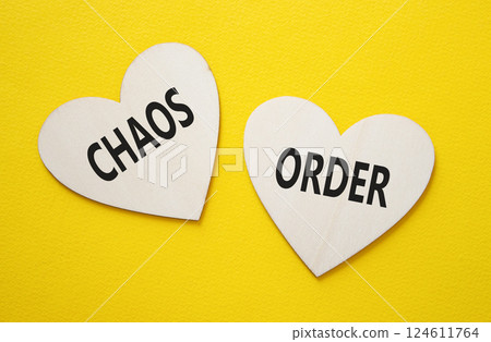 Chaos or Order symbol. Concept word Chaos or Order on wooden hearts. Beautiful white background. Business and Chaos or Order concept. Copy space 124611764