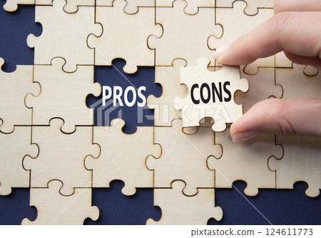 Pros vs Cons symbol. Concept word Pros vs Cons on wooden puzzle. Businessman hand. Beautiful deep blue background. Business and Pros vs Cons concept. Copy space Pros vs Cons symbol. Concept word Pros vs Cons on wooden puzzle. Businessman hand. Beautiful deep blue background. Business and Pros vs Cons concept. Copy space 124611773