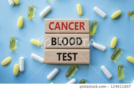 Cancer Blood Test symbol. Concept word Cancer Blood Test on wooden blocks. Beautiful blue background with pills. Medicine and Cancer Blood Test concept. Copy space 124611807
